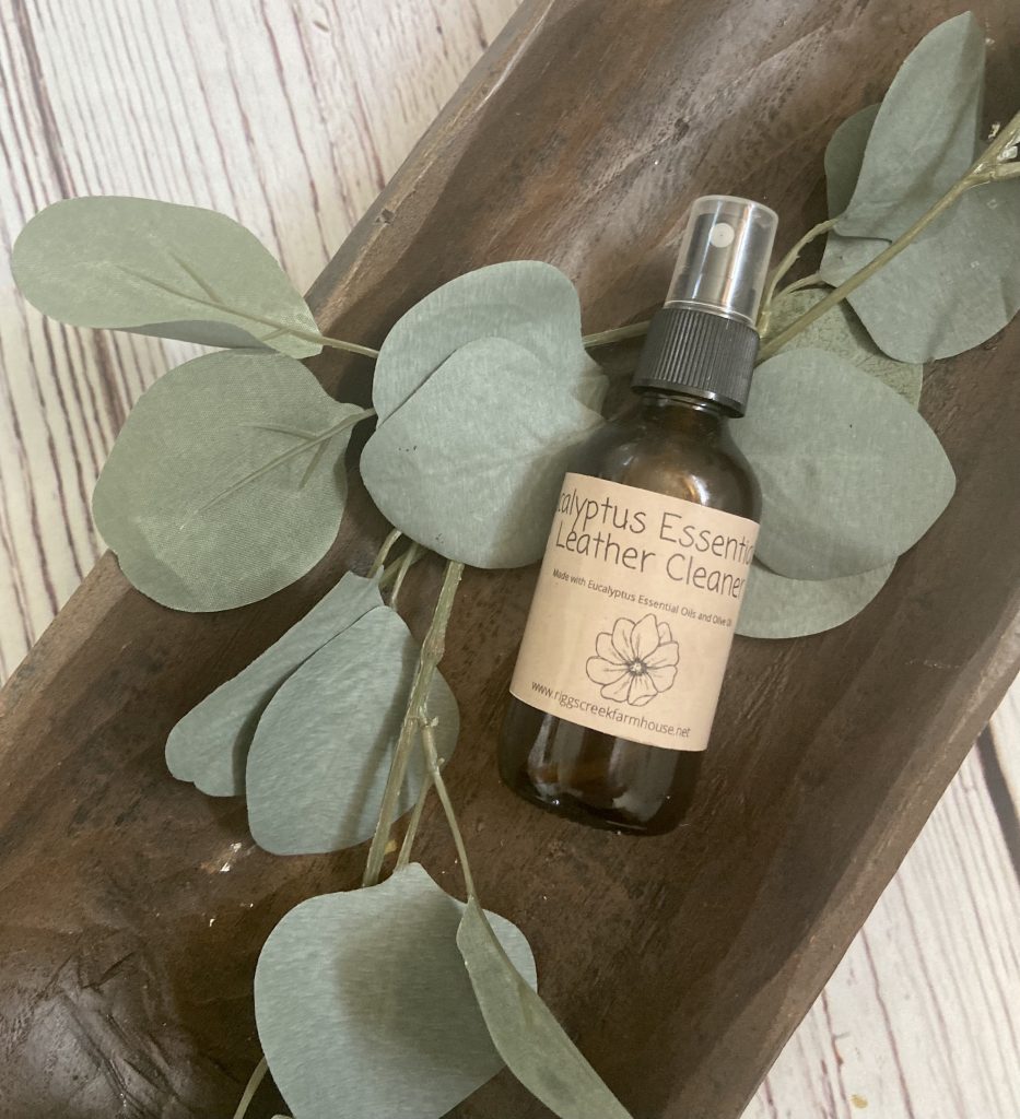 natural leather cleaner using essential oils in a dough bowl with eucalyptus leaves