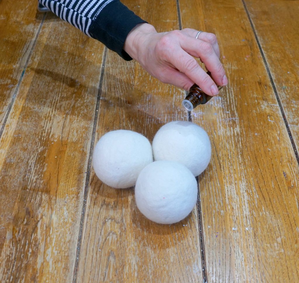 dropping essential oils on a dryer ball