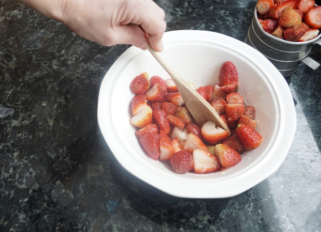 mixing a bowl of fresh strawberries