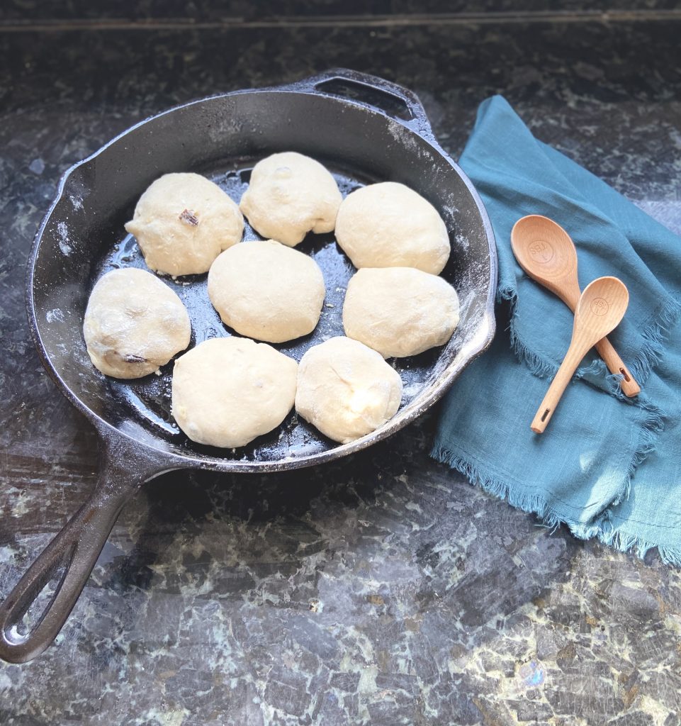 sourdough hot cross buns in a cast iron skillet