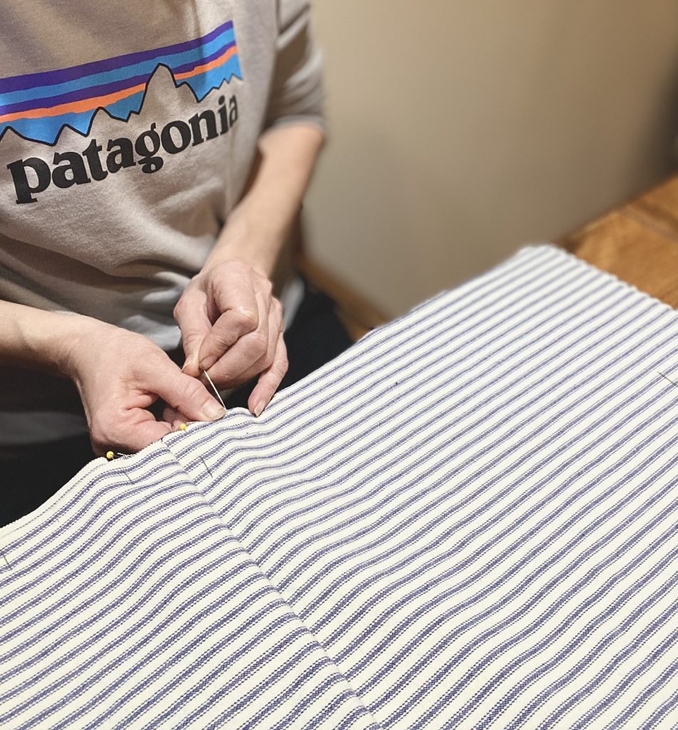 woman pinning a cutting for a beginning sewing project