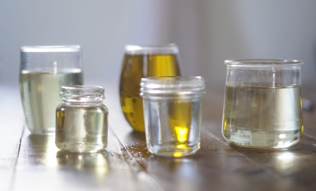 carrier oils displayed in various glass jars