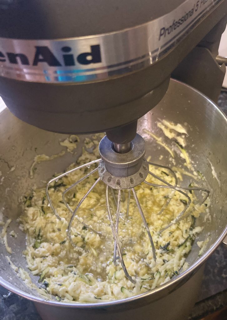 shredded zucchini in a stand-up mixer