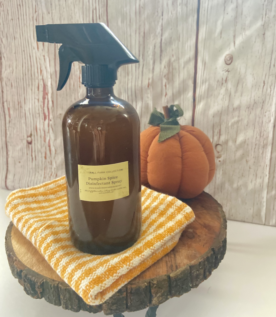 Homemade Disinfectant Spray sitting on a checked white and orange towel