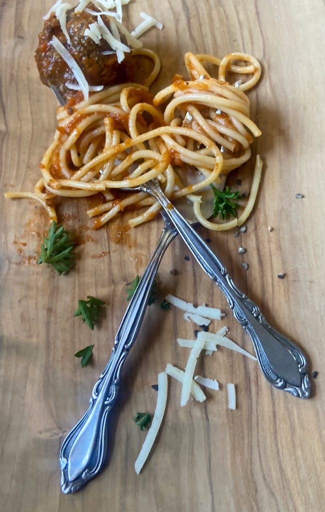 spaghetti sauce and noodles wrapped around a fork