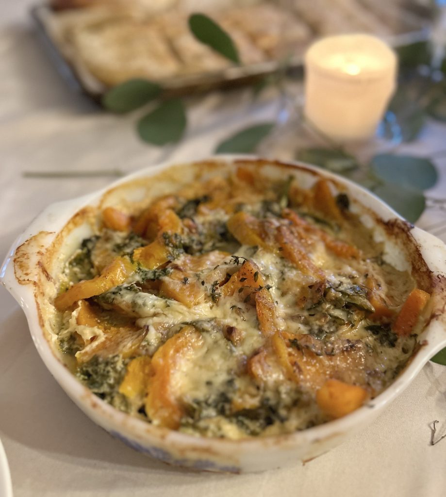 Simple Squash Casserole with Gruyere Cheese placed on a table next to a candle